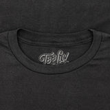 Close-up of a black t-shirt with 'Tee Luv' logo on the collar.