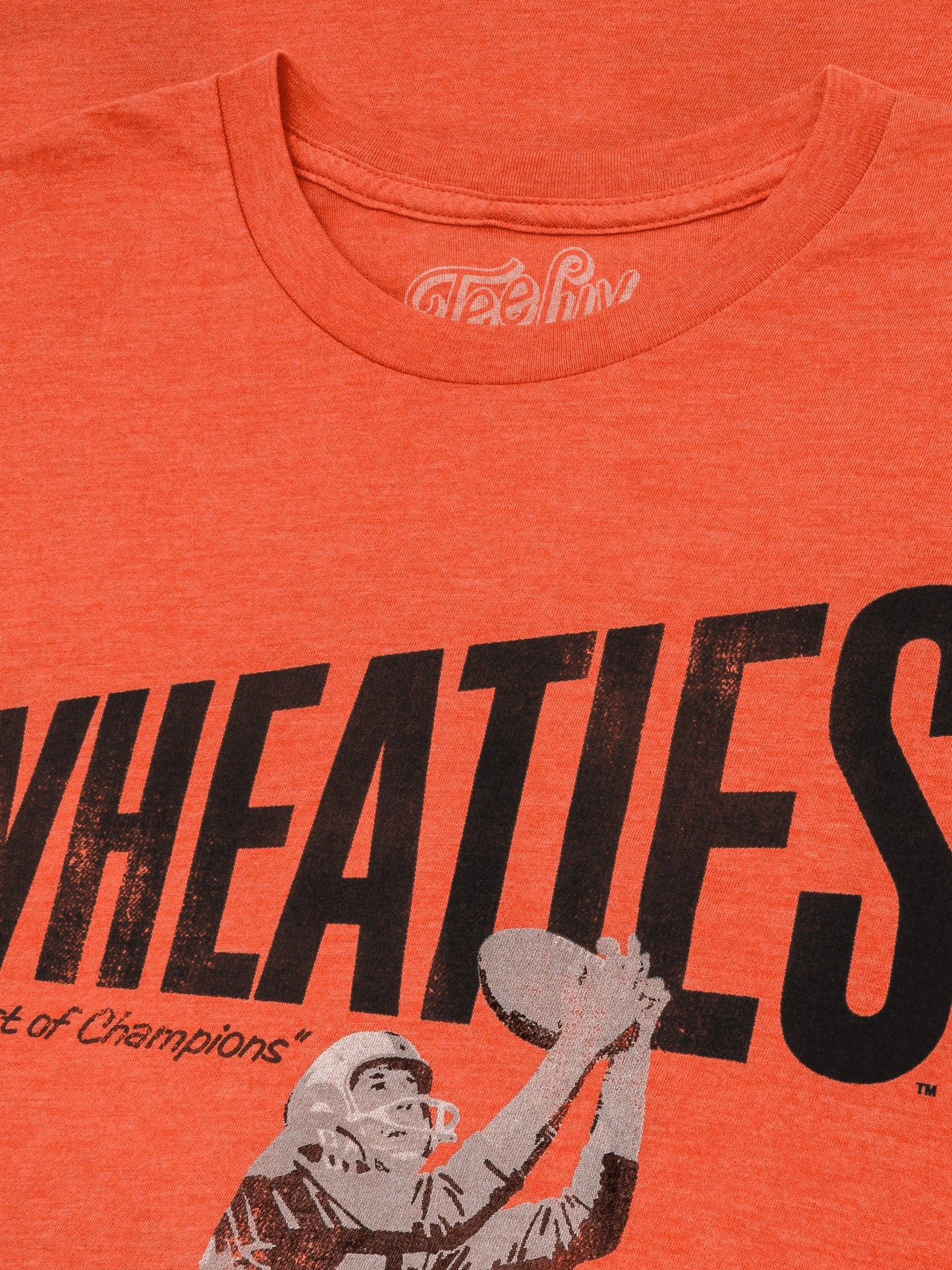 Orange t-shirt with 'Wheaties' branding and a graphic of a football player.