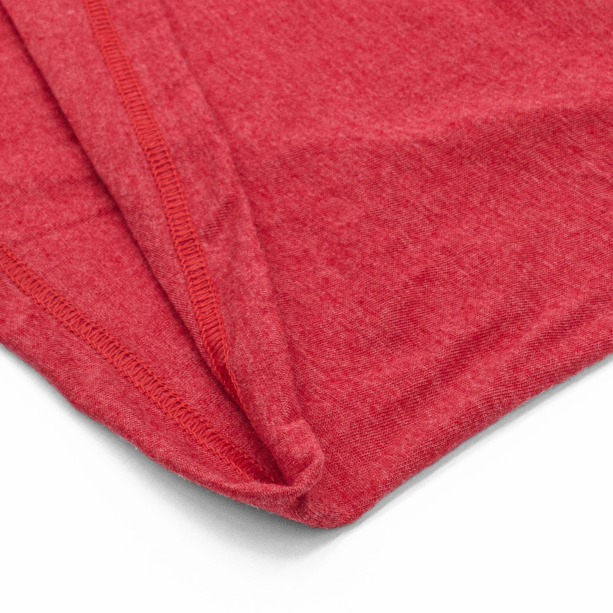 Close-up of a red fabric with a textured surface on a white background