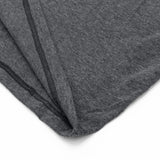 Close-up of gray fabric with a subtle pattern on a white background