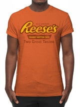 Person wearing an orange t-shirt with Reese's Peanut Butter Cups branding.