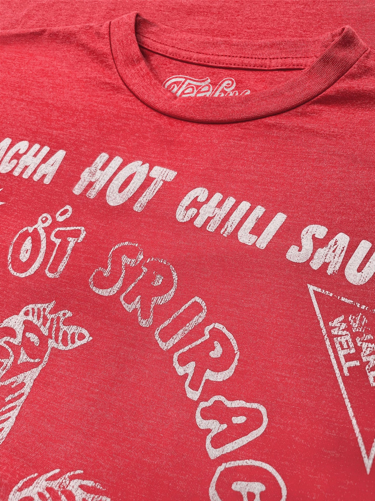 Red t-shirt with white text and graphics on a red background