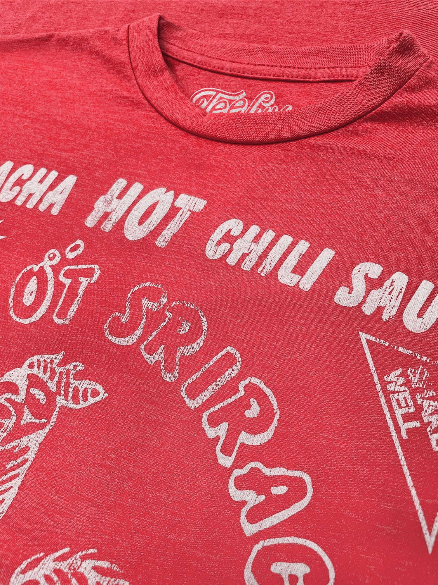 Red t-shirt with white text and graphics on a red background