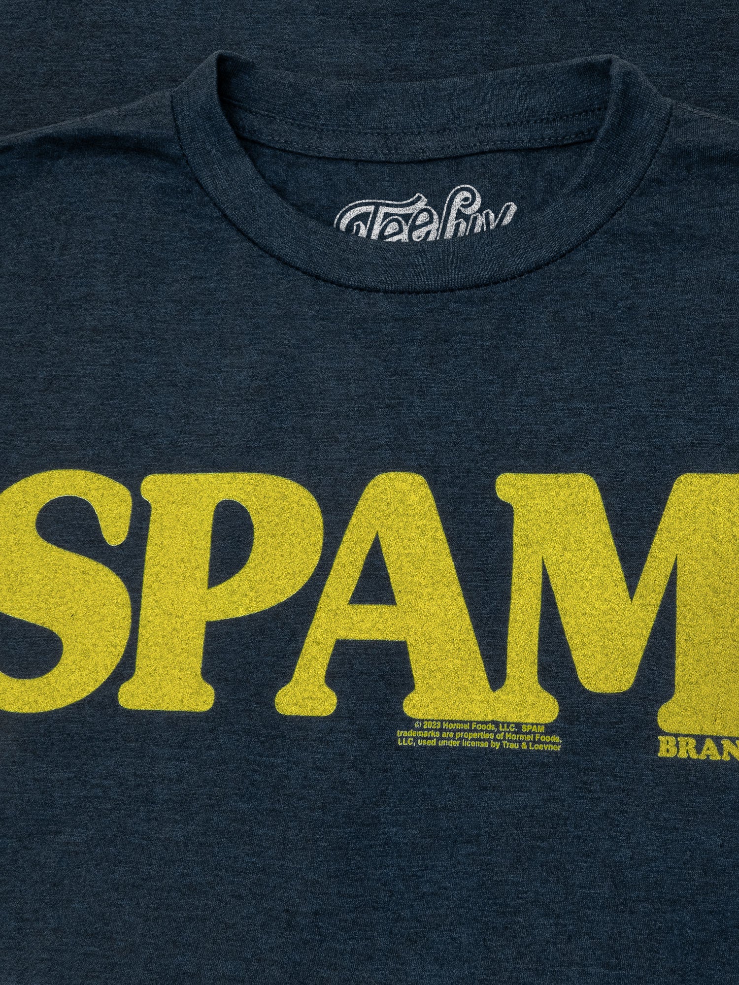 Navy blue t-shirt with yellow 'SPAM' branding on a dark background