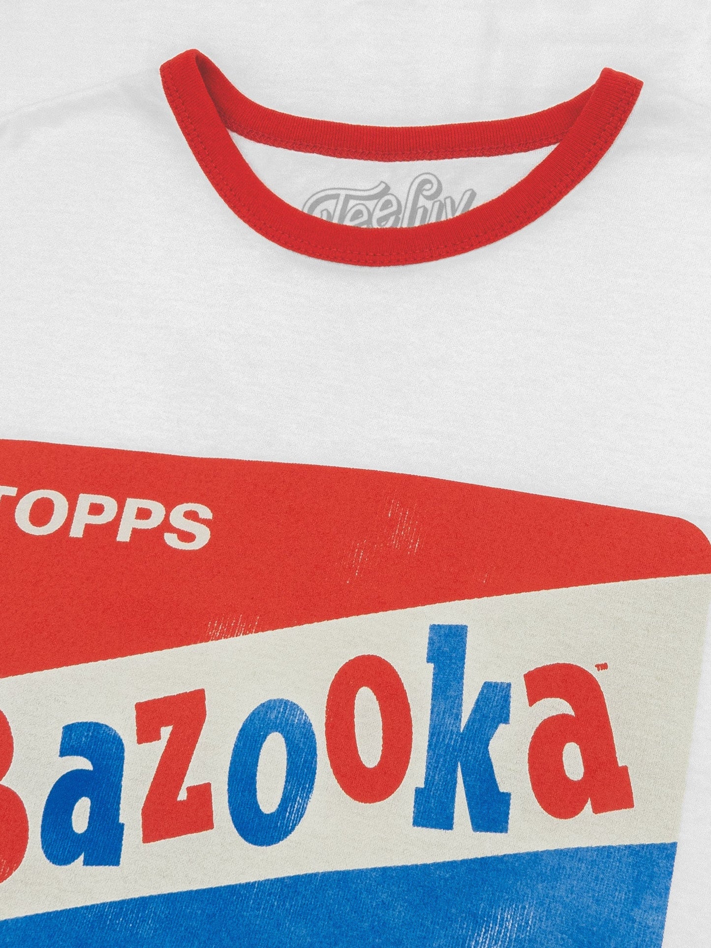 Close-up of a shirt with Bazooka and Topps branding on a white background