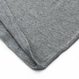 Close-up of gray fabric with a visible seam on a white background