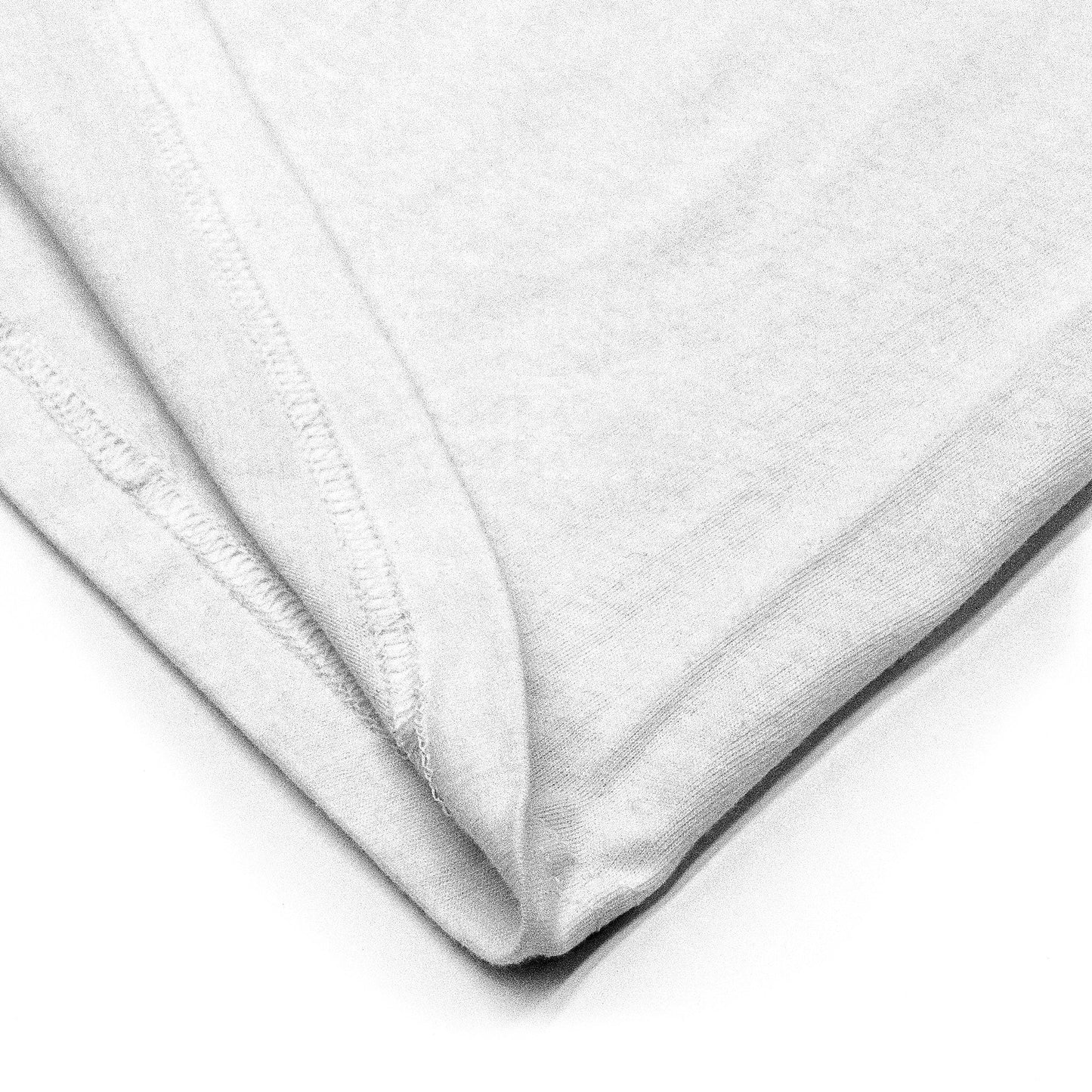 Close-up of a white fabric with a subtle pattern on a white background