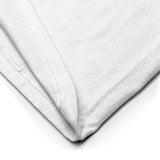 Close-up of a white fabric with a subtle pattern on a white background