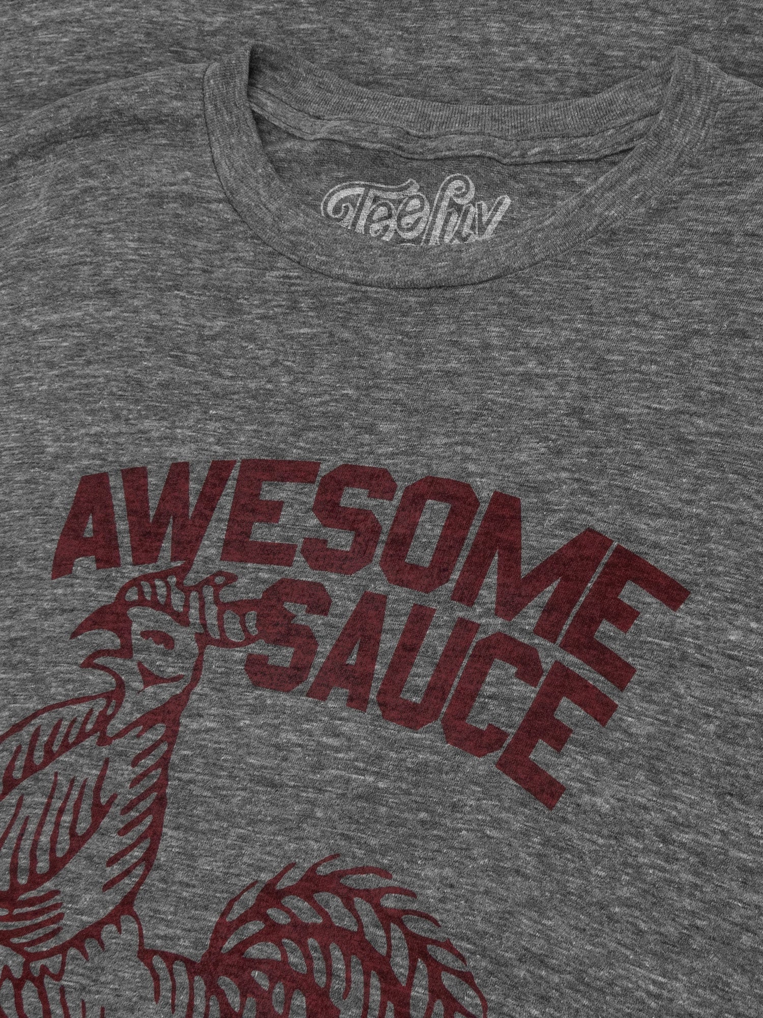 Gray t-shirt with 'Awesome Sauce' graphic and logo on a dark background