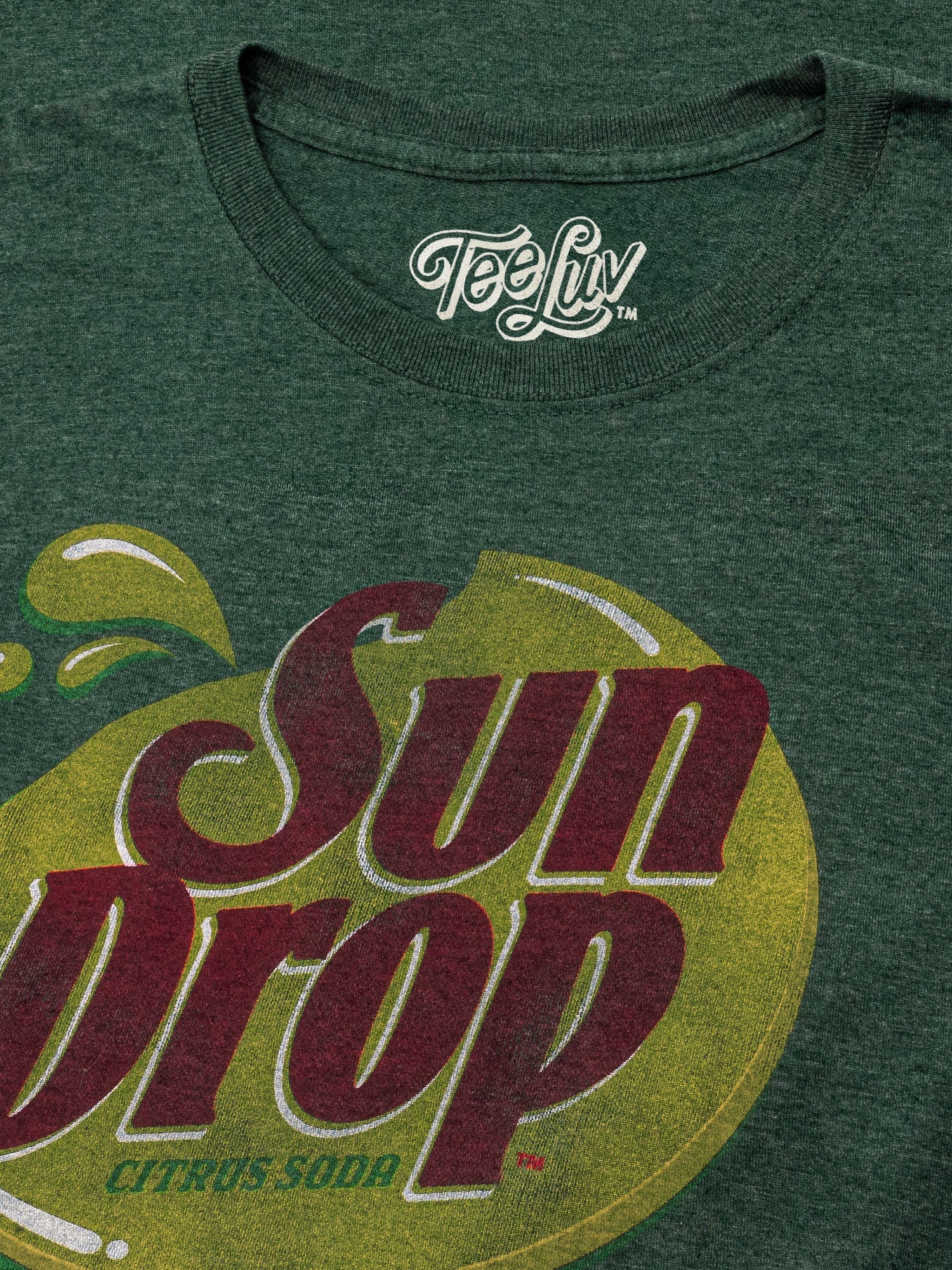 Green t-shirt with Sun Drop Citrus Soda logo and 'Tee Luv' branding.