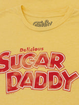 Yellow t-shirt with red and white text 'Delicious Sugar Daddy' on a yellow background
