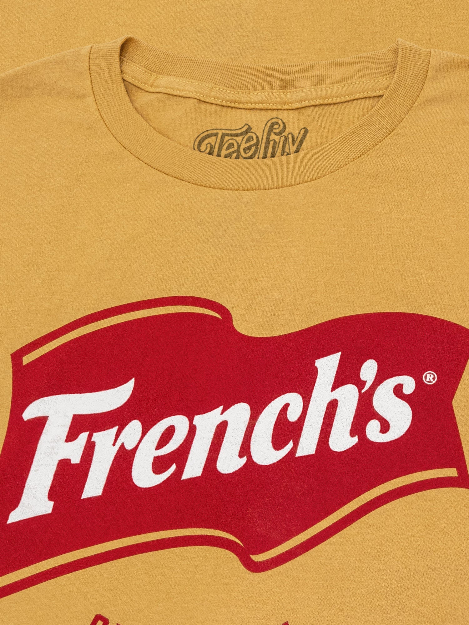Yellow t-shirt with red 'French's' logo on a mustard background