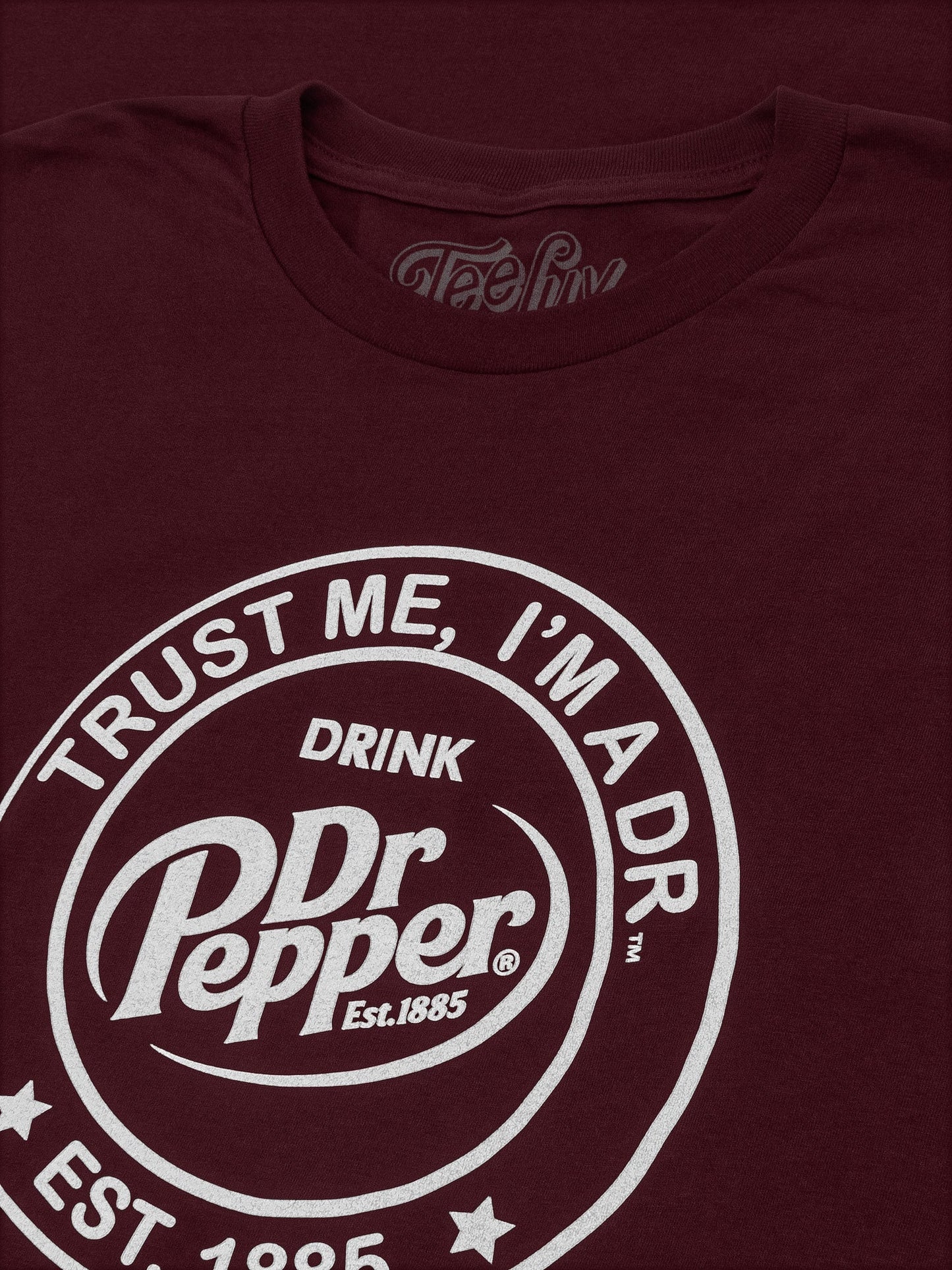 Maroon t-shirt with Dr Pepper logo and text on a dark background