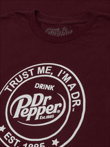 Maroon t-shirt with Dr Pepper logo and text on a dark background