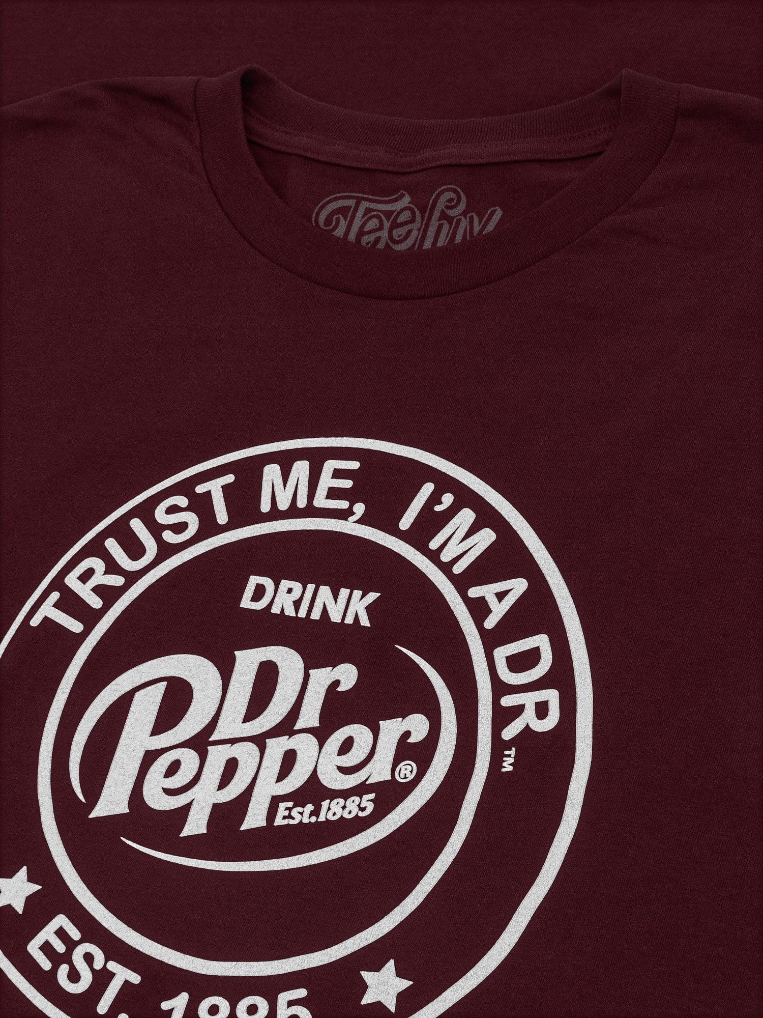 Maroon t-shirt with Dr Pepper logo and text on a dark background