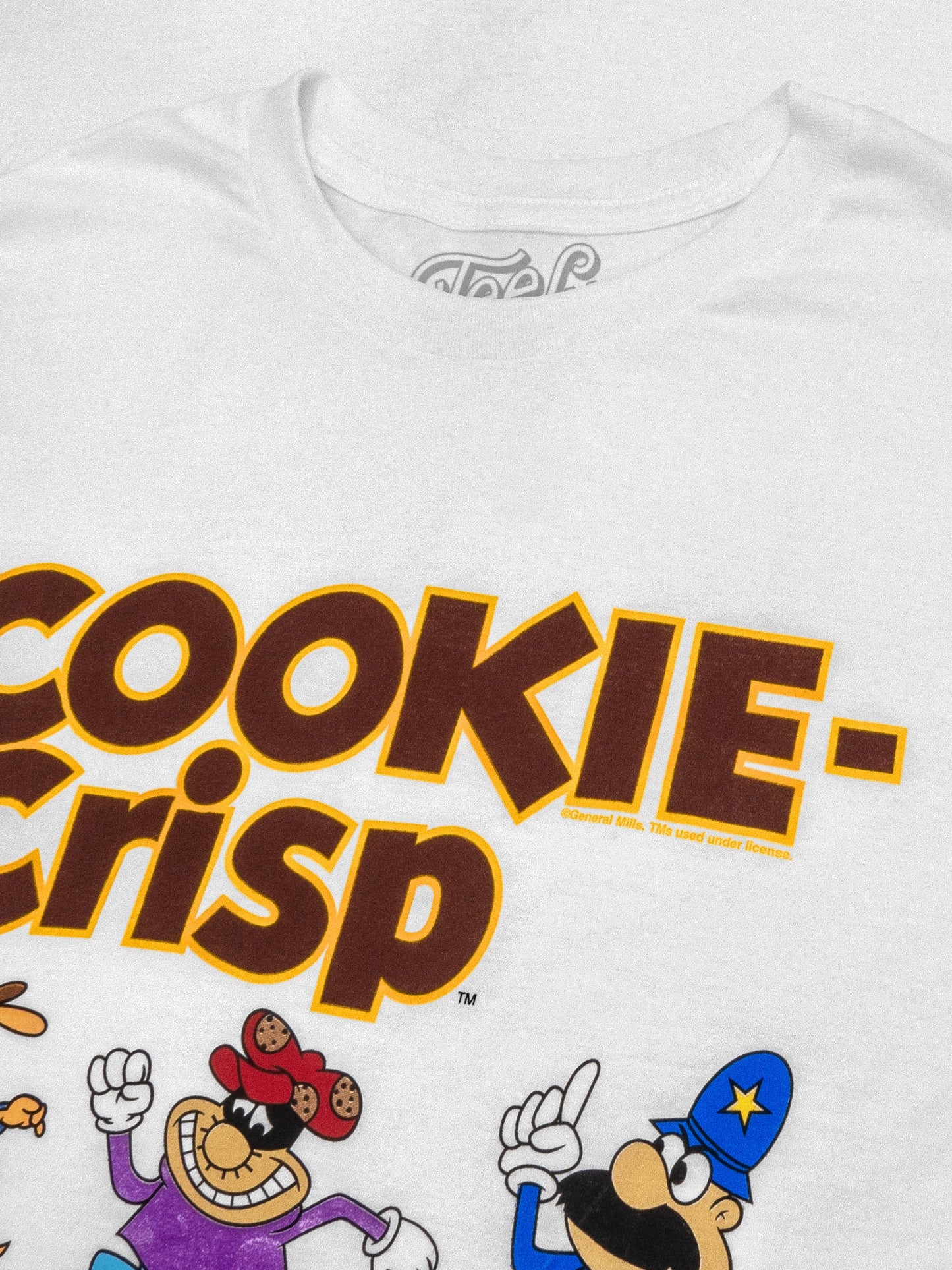 White t-shirt with 'Cookie Crisp' text and cartoon characters on a white background