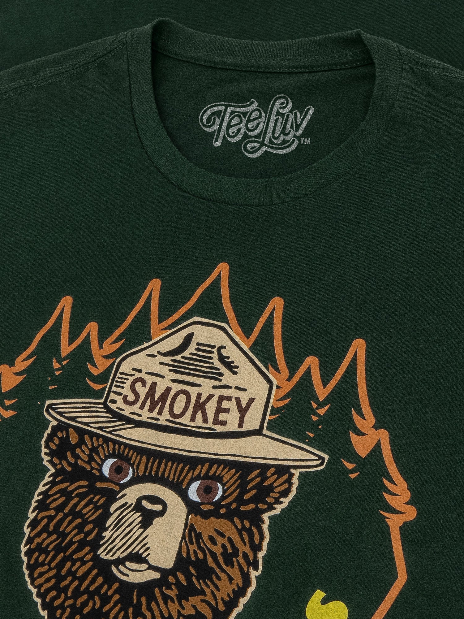 Green t-shirt with Smokey Bear graphic and 'Tee Luv' branding
