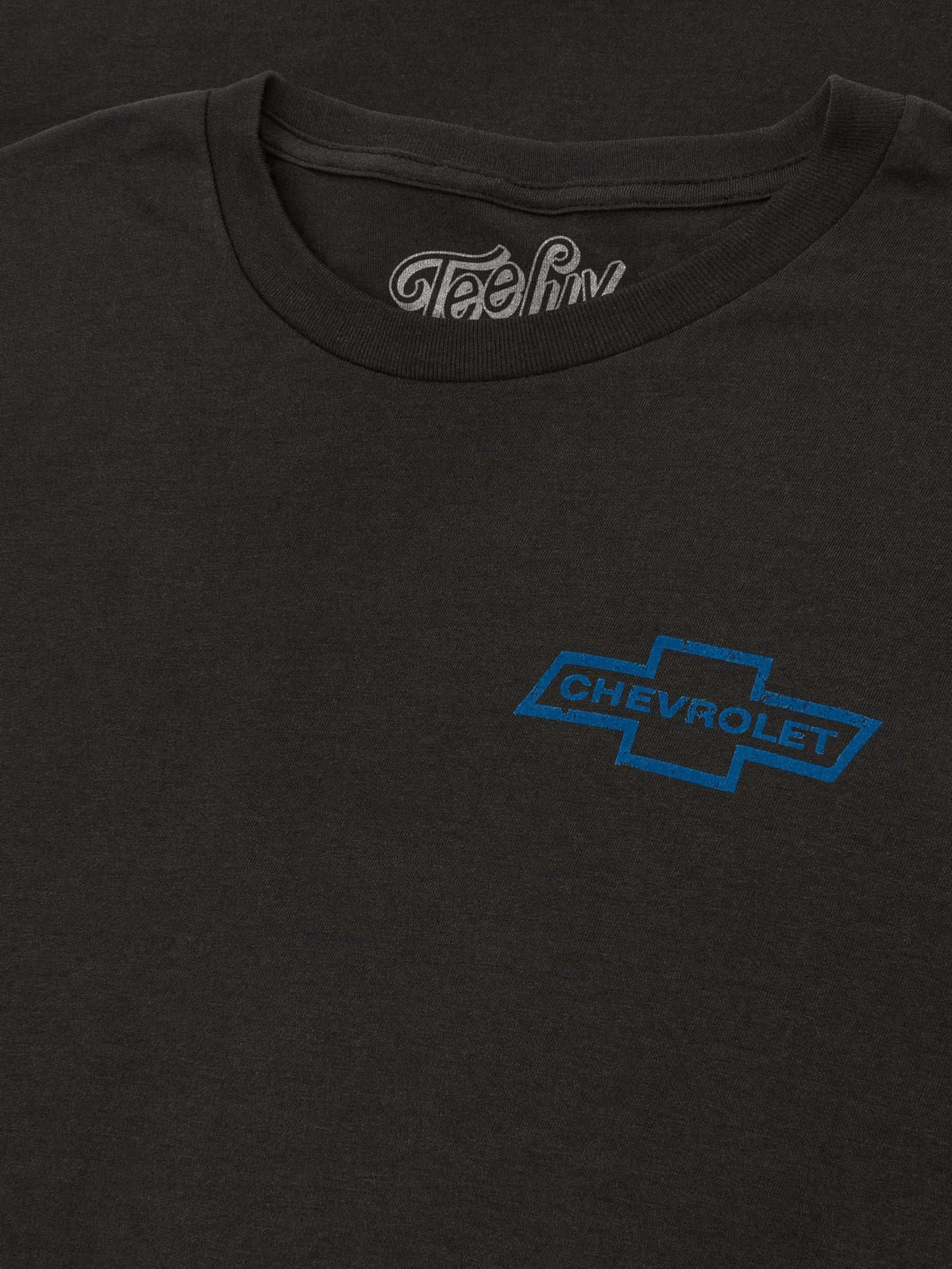 Black t-shirt with a blue Chevrolet logo on a plain background