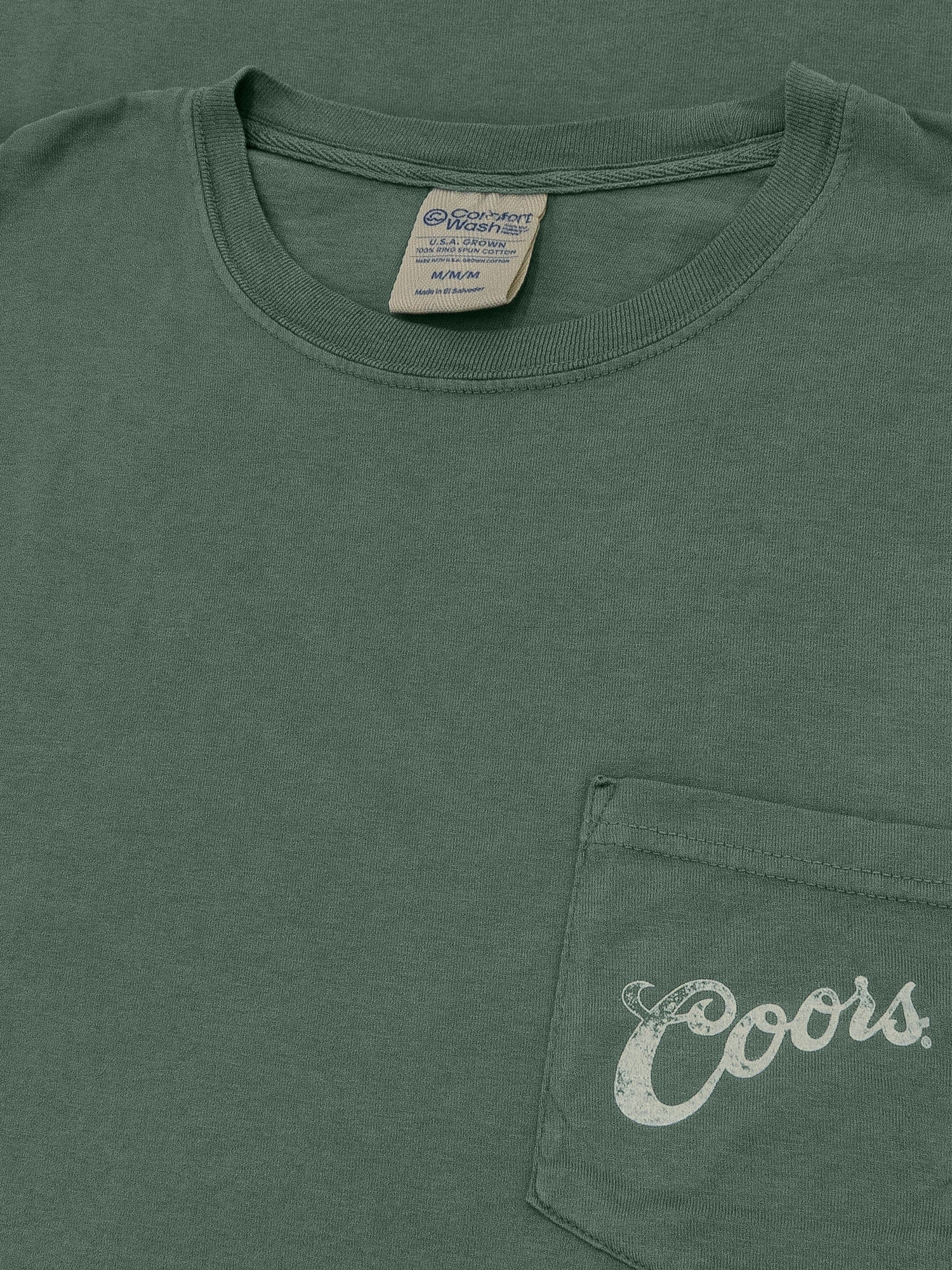 Green t-shirt with 'Coors' logo on chest pocket and tag visible.