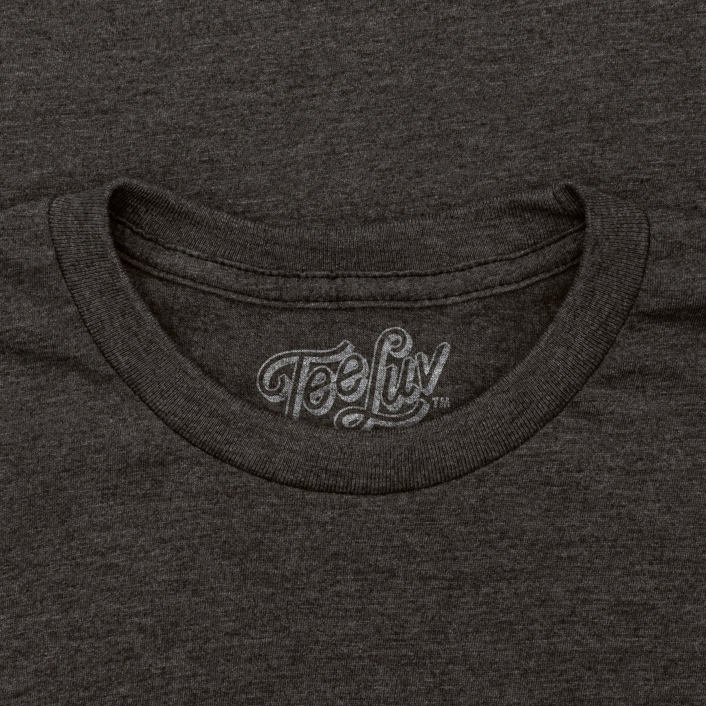 Close-up of a dark gray t-shirt with 'Tee Luv' logo on the collar.
