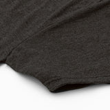 Close-up of a dark gray t-shirt on a white background