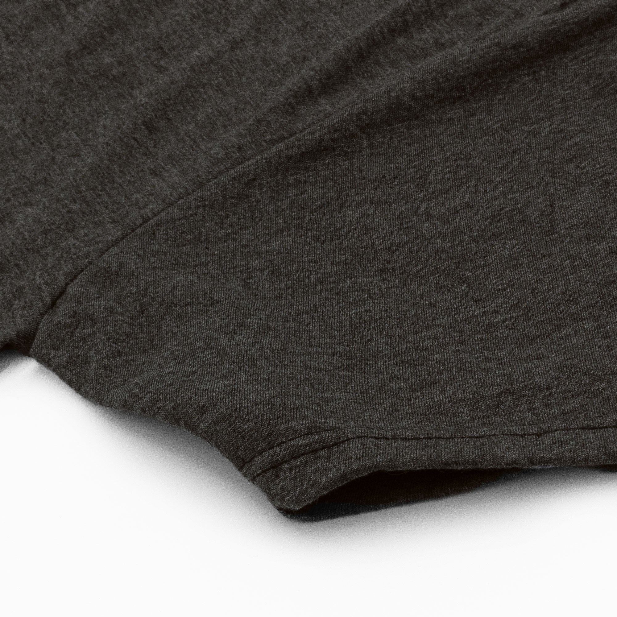 Close-up of a dark gray t-shirt on a white background