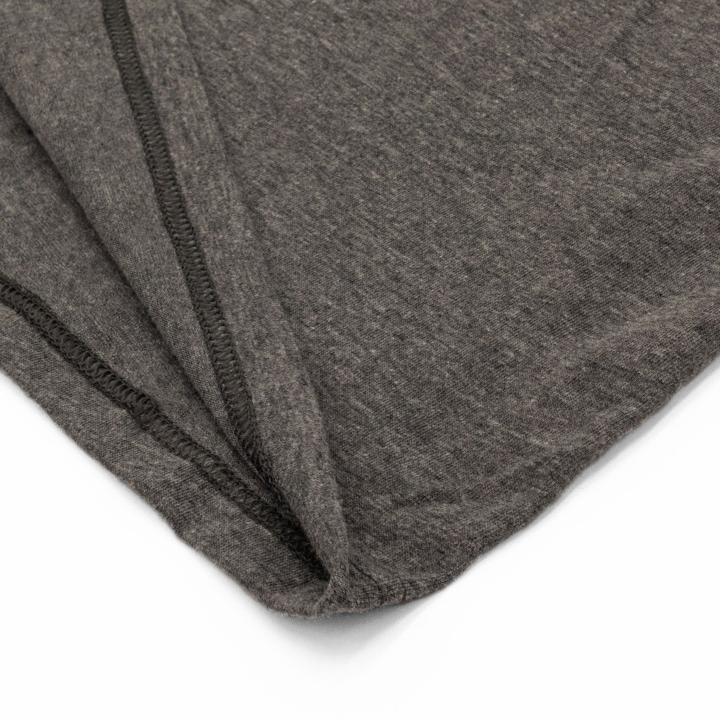 Close-up of gray fabric with a subtle pattern on a white background