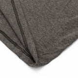 Close-up of gray fabric with a subtle pattern on a white background