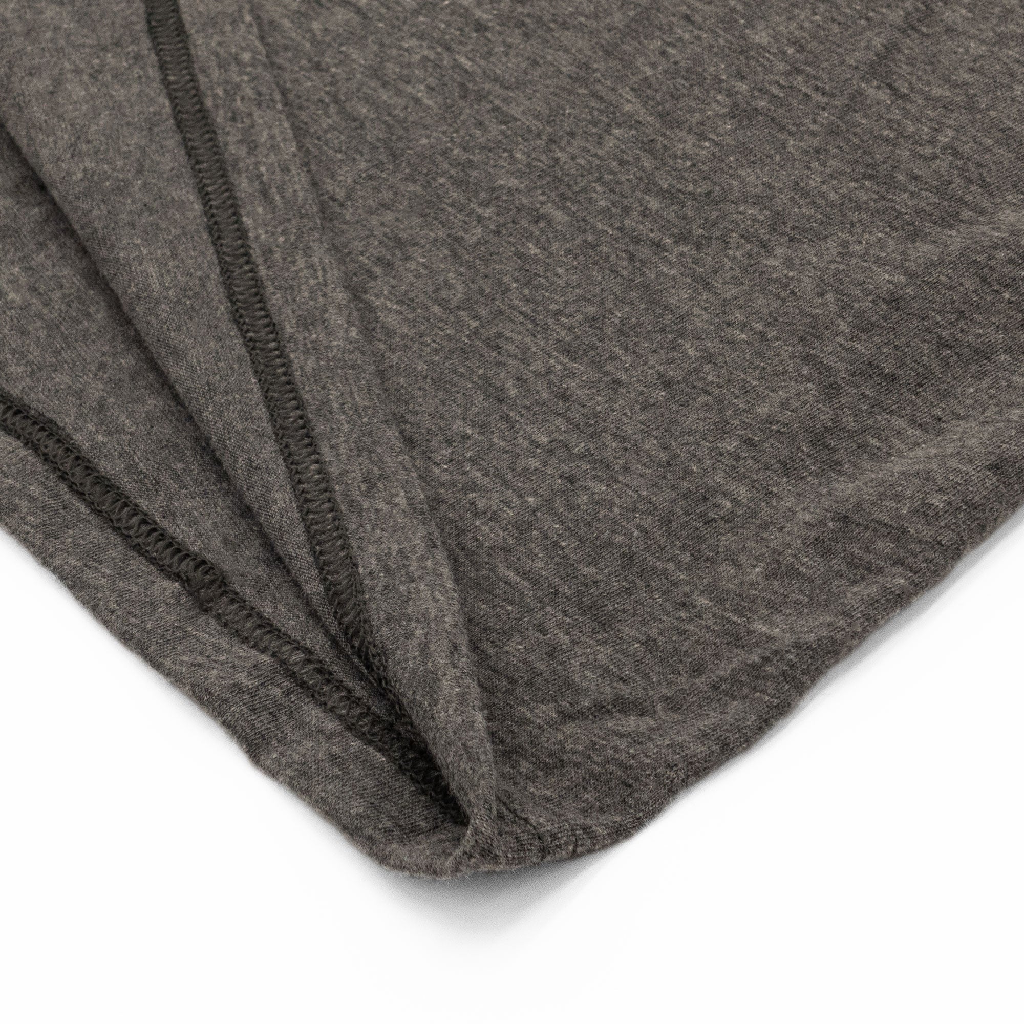 Close-up of gray fabric with a subtle pattern on a white background
