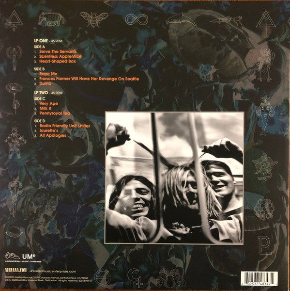Album cover with text and black and white photo of three people, featuring a dark, abstract design.